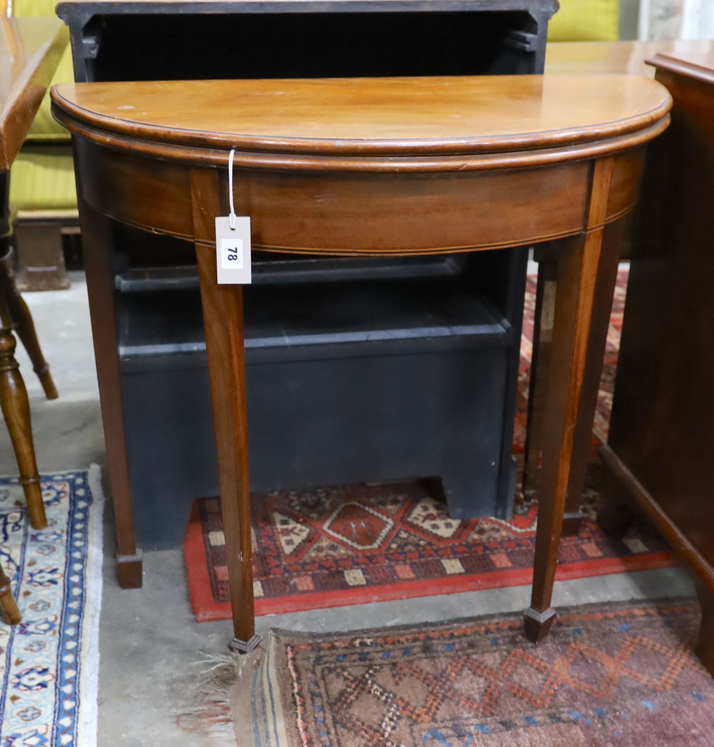 A George III mahogany D-shaped folding tea table, width 39cm, depth 80cm, height 73cm